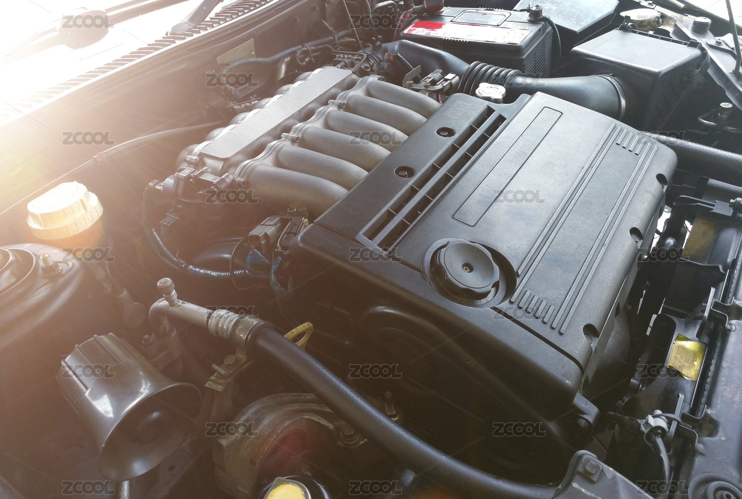 Unbranded car engine with sun flare .
